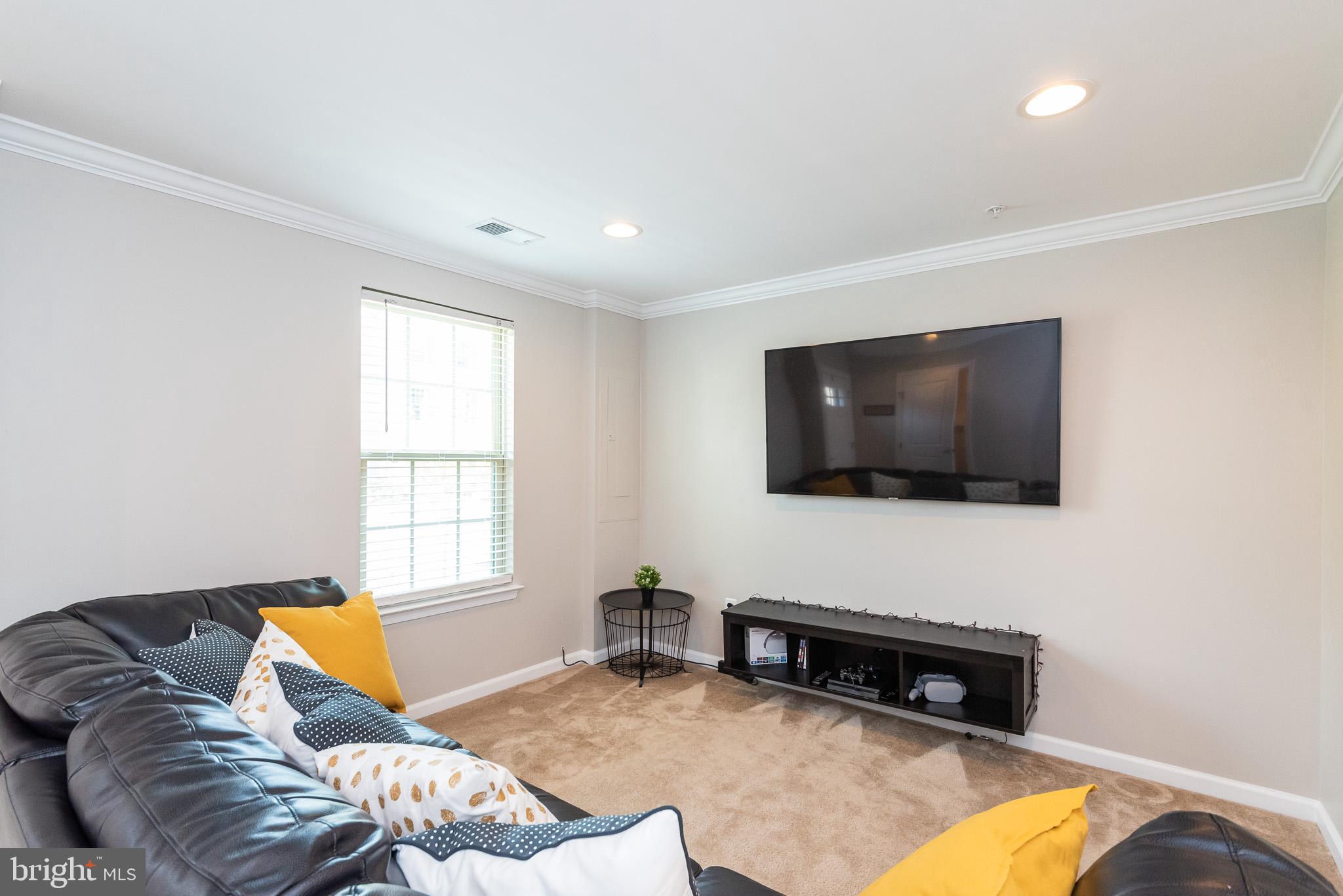 1038 Ramble Run Road Baltimore, MD 21220 - Photo 8 of 47 a living room with furniture and a flat screen tv