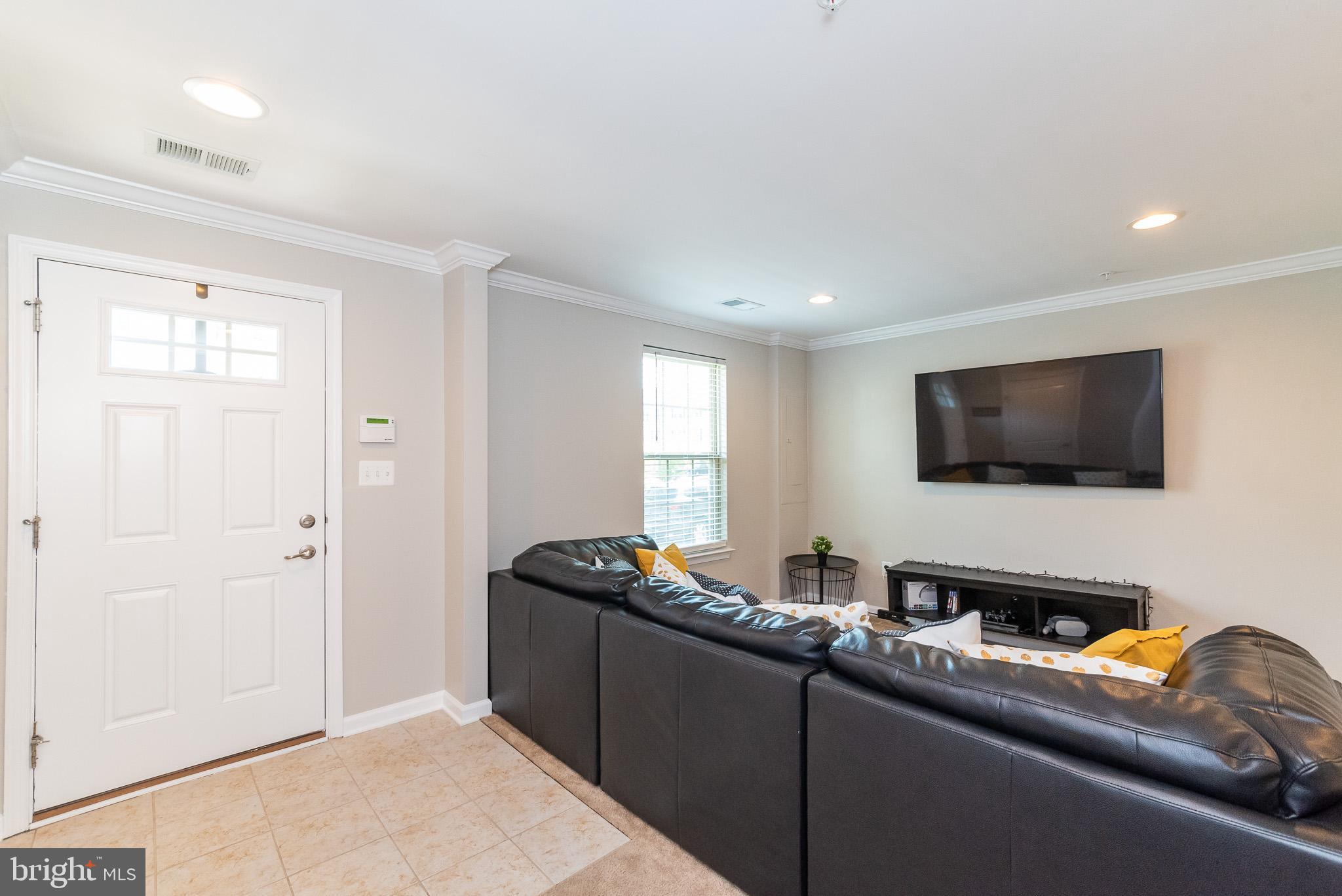 1038 Ramble Run Road Baltimore, MD 21220 - Photo 10 of 47 a living room with furniture and a flat screen tv
