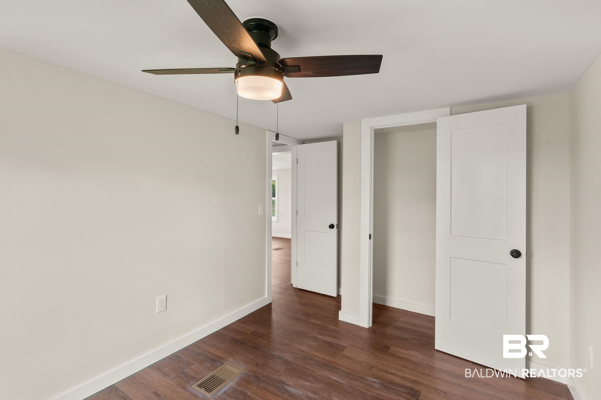 12645 Breman Road Elberta, AL 36530 - Photo 30 of 44 Unfurnished bedroom featuring dark wood-style floors, visible vents, baseboards, and a ceiling fan
