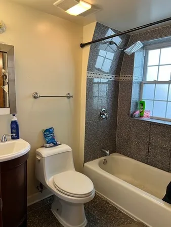 a bathroom with a sink toilet and shower