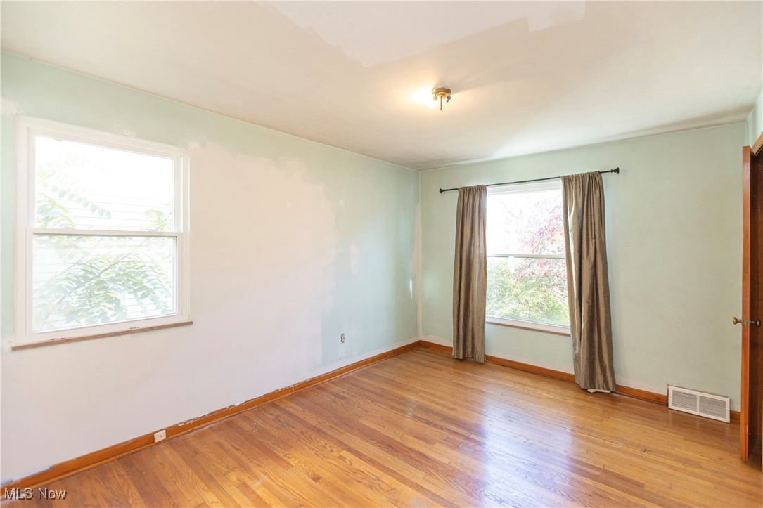 6168 Manchester Road Parma, OH 44129 - Photo 11 of 25 Spacious bedroom with well maintained hardwood floors and large windows