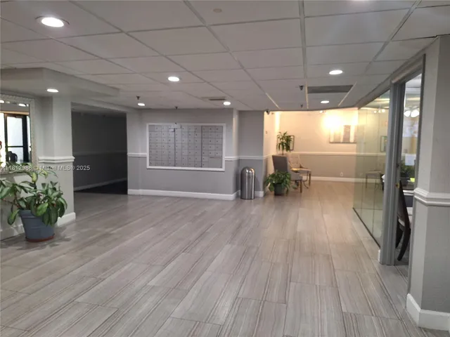 a view of a big room with wooden floor and a window