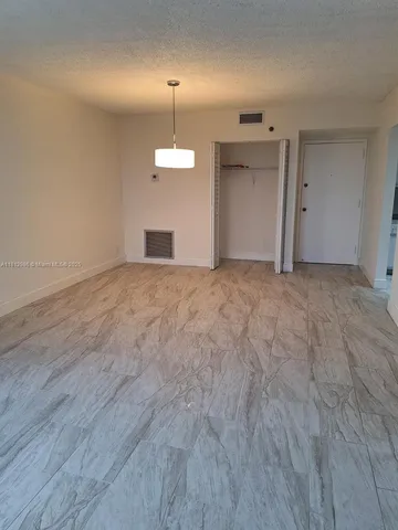 an empty room with a empty space and a window