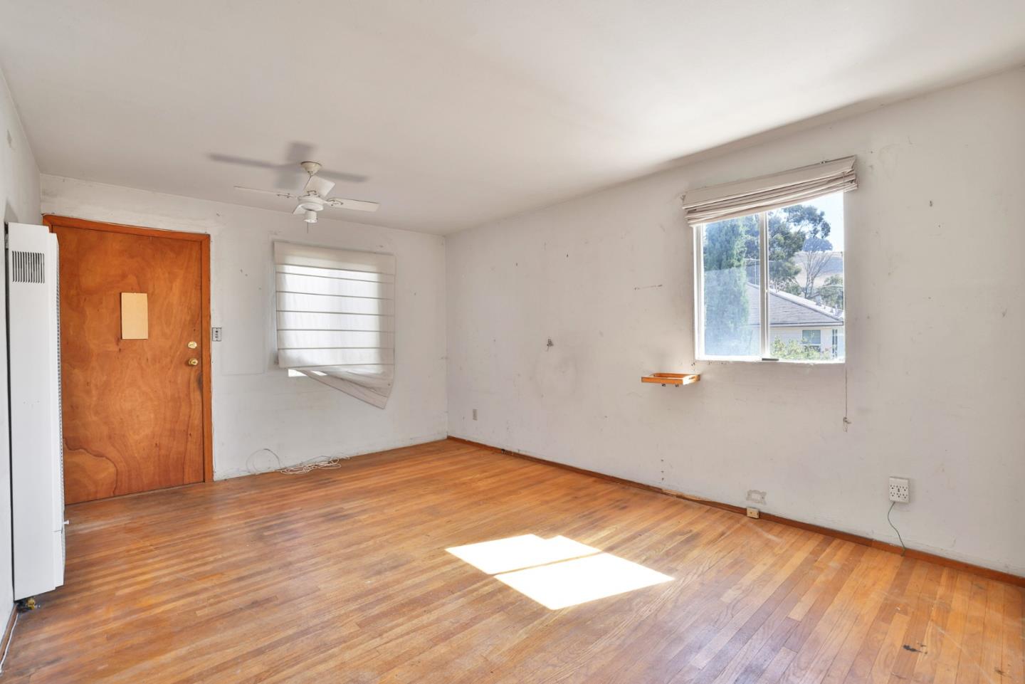 2291 Upland Road San Leandro, CA 94578 - Photo 9 of 32 a view of an empty room with wooden floor and a window