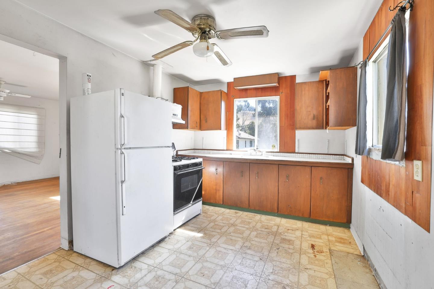 2291 Upland Road San Leandro, CA 94578 - Photo 10 of 32 a kitchen with granite countertop a refrigerator a sink and dishwasher