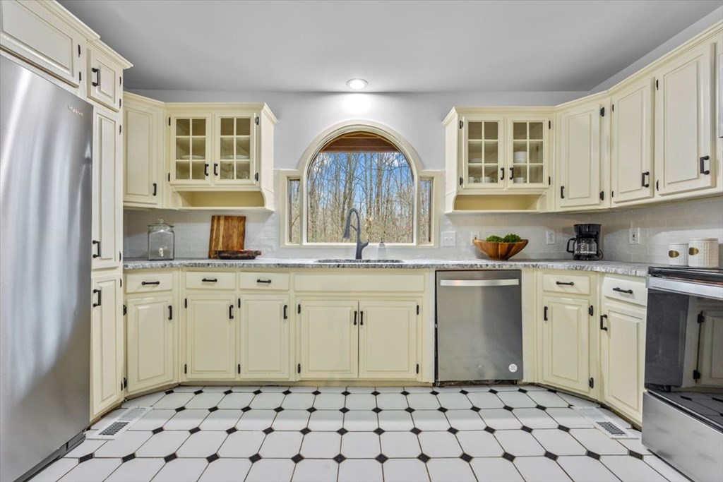 10 Johnson Ford Road Epworth, GA 30541 - Photo 11 of 50 a kitchen with granite countertop a sink window and cabinets