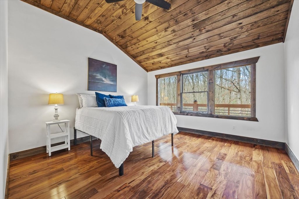 10 Johnson Ford Road Epworth, GA 30541 - Photo 22 of 50 a bedroom with a bed lamp on table and a large window