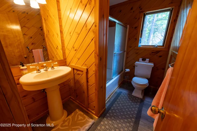 a bathroom with a sink mirror and toilet