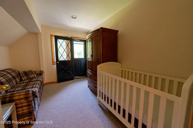 a bathroom with a tub a sink and a large mirror next to a window