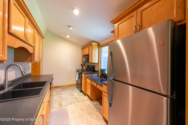 a kitchen with stainless steel appliances a refrigerator and a sink