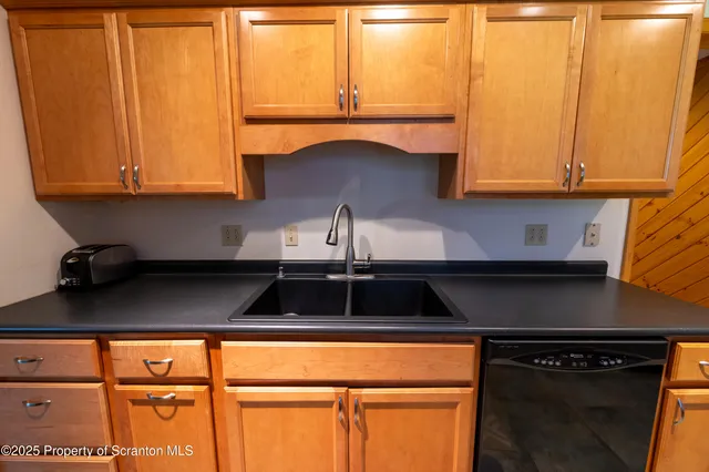 a kitchen with a sink a stove and cabinets