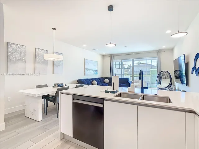 a kitchen with a sink and a stove top oven