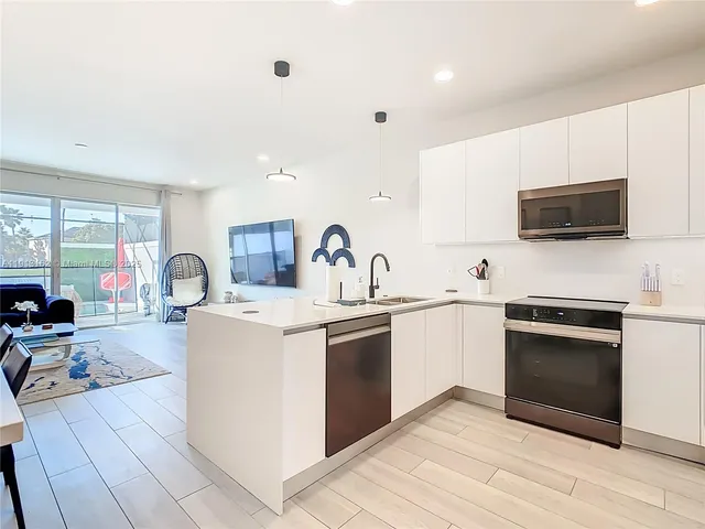 a kitchen with a sink stove and refrigerator