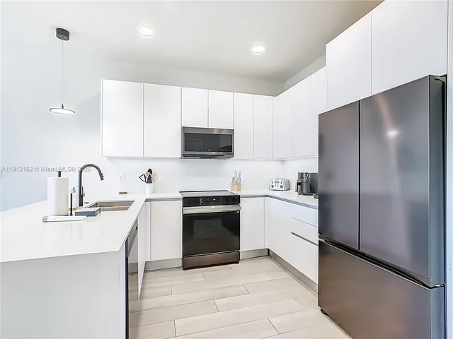 a kitchen with a refrigerator and cabinets