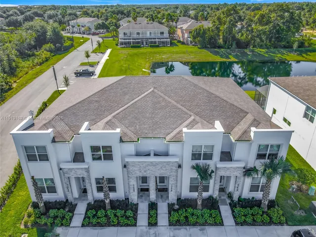 a aerial view of a house with a yard and a swimming pool