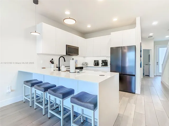 a large kitchen with lots of counter space and furniture