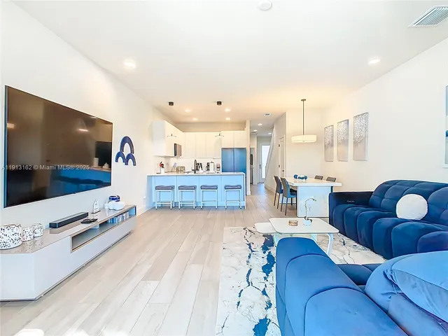 a view of a dining room with furniture water floor and kitchen view