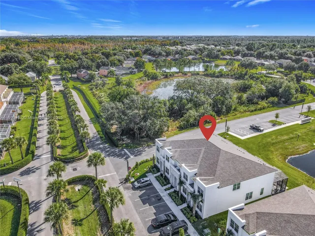 an aerial view of residential houses with outdoor space and swimming pool