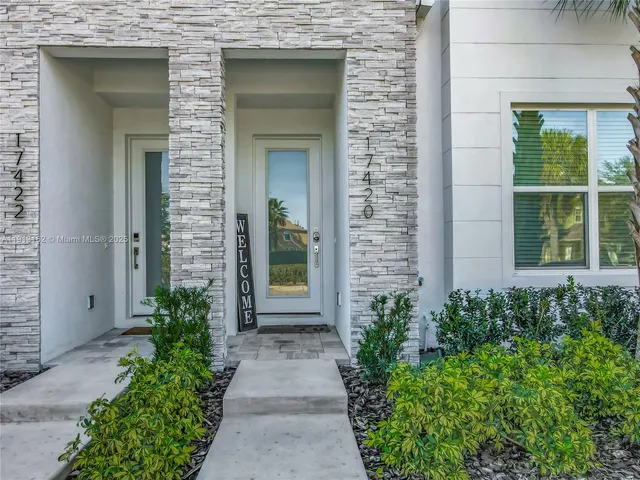 a front view of a house with a blue gate
