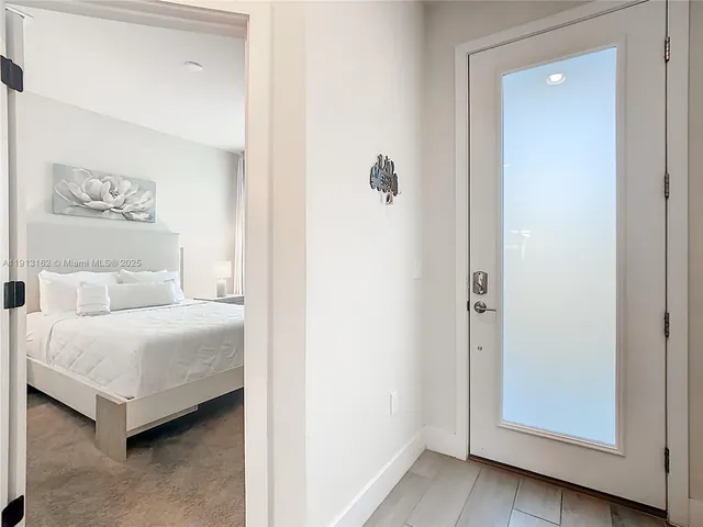 a room with a bed and a painting on the wall