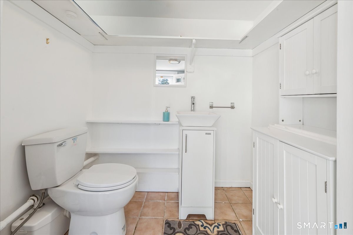 11 Margaret Street Norwalk, CT 06851 - Photo 22 of 26 a white toilet sitting next to a bathroom sink