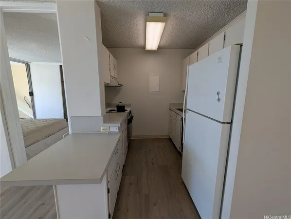 a kitchen with a refrigerator and a sink