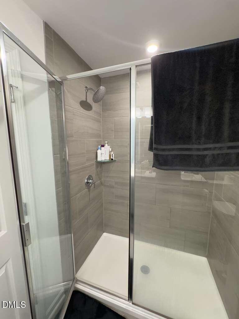 13031 Rover Street Charlotte, NC 28273 - Photo 7 of 29 a bathroom with a shower and a sink