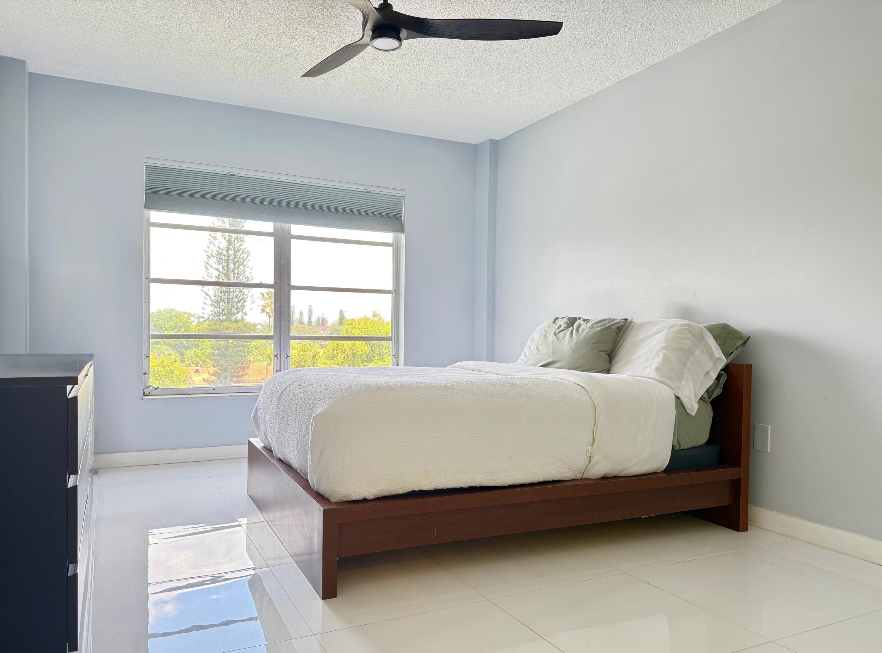4164 Inverrary Drive, Unit 404 Lauderhill, FL 33319 - Photo 12 of 23 a large bed sitting in a bedroom next to a window