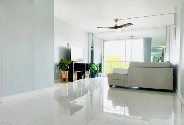 a living room with furniture and a large window