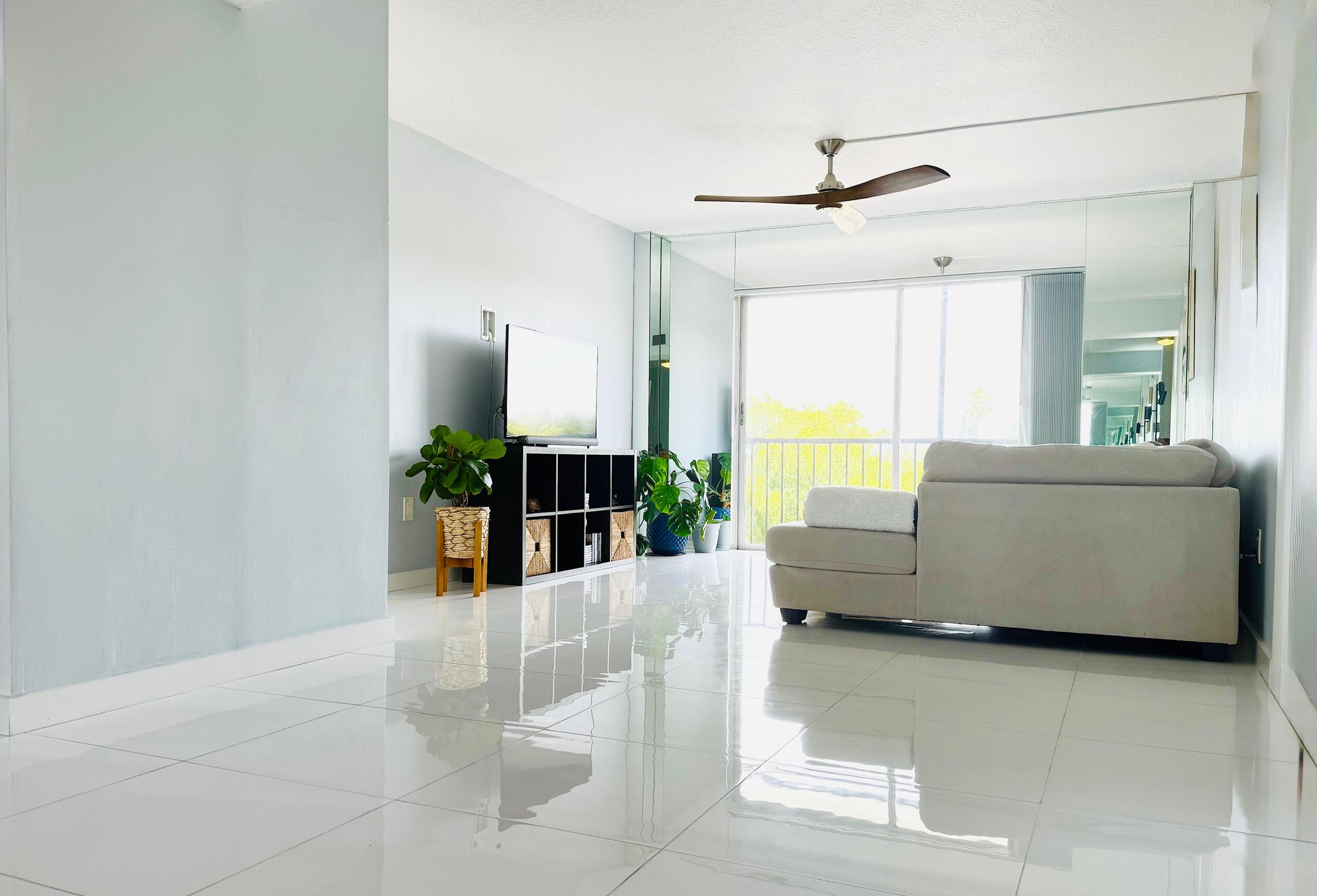 4164 Inverrary Drive, Unit 404 Lauderhill, FL 33319 - Photo 7 of 23 a living room with furniture and a large window