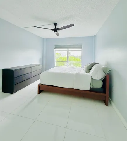 a bed room with a bed and a window