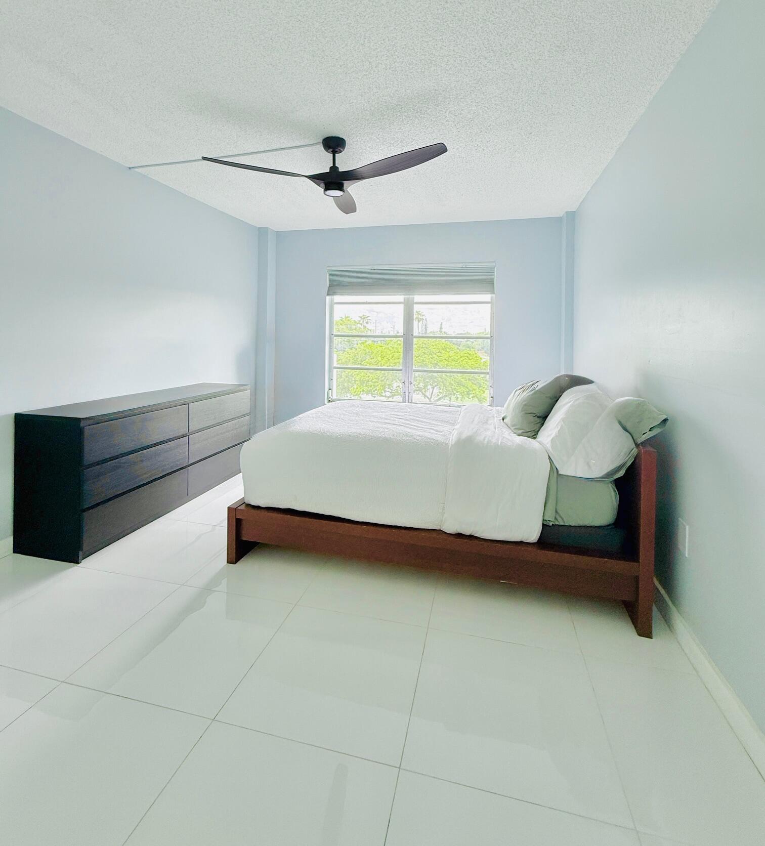 4164 Inverrary Drive, Unit 404 Lauderhill, FL 33319 - Photo 10 of 23 a bed room with a bed and a window