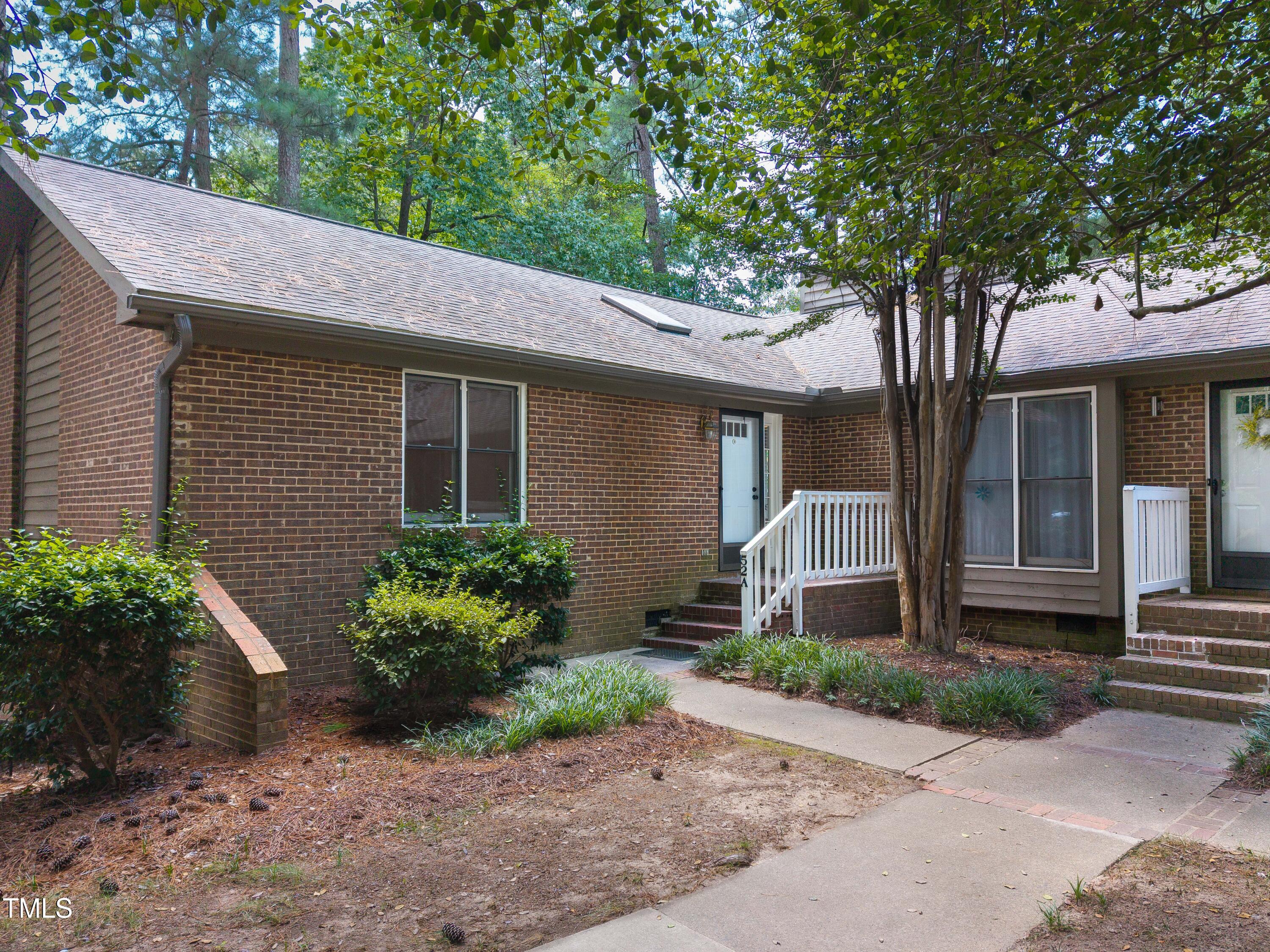 200 West Woodcroft Parkway, Unit 52A Durham, NC 27713 - Photo 1 of 21 a front view of a house with garden