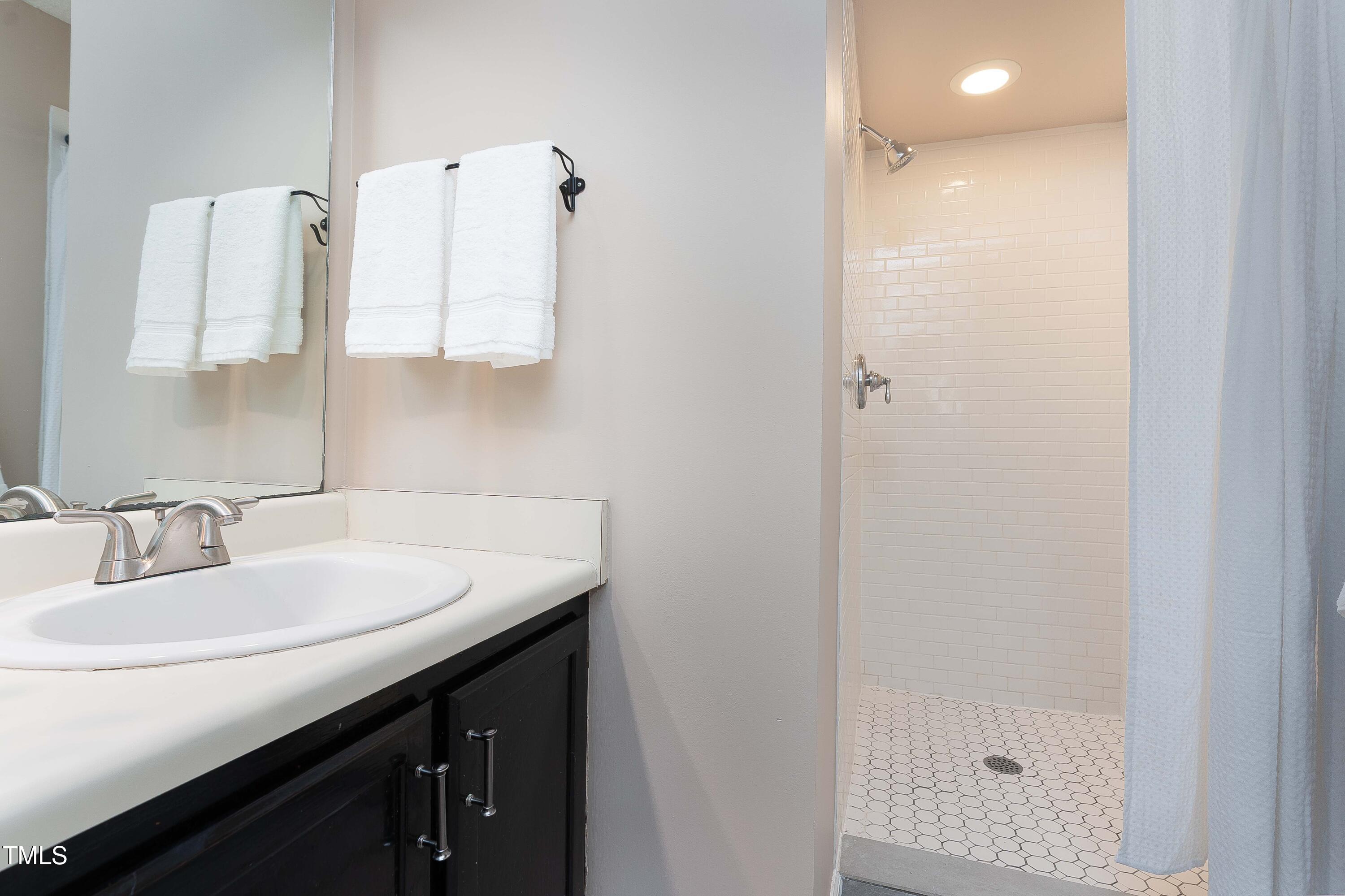 200 West Woodcroft Parkway, Unit 52A Durham, NC 27713 - Photo 14 of 21 a bathroom with a sink and a mirror