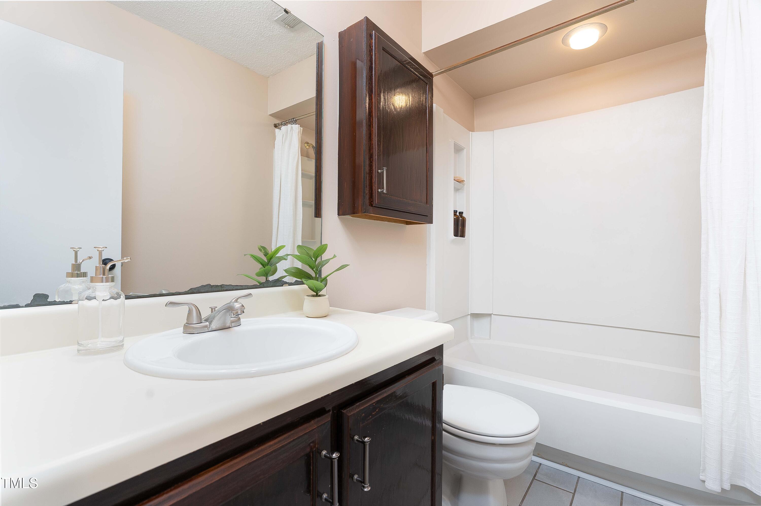200 West Woodcroft Parkway, Unit 52A Durham, NC 27713 - Photo 16 of 21 a bathroom with a sink and a mirror
