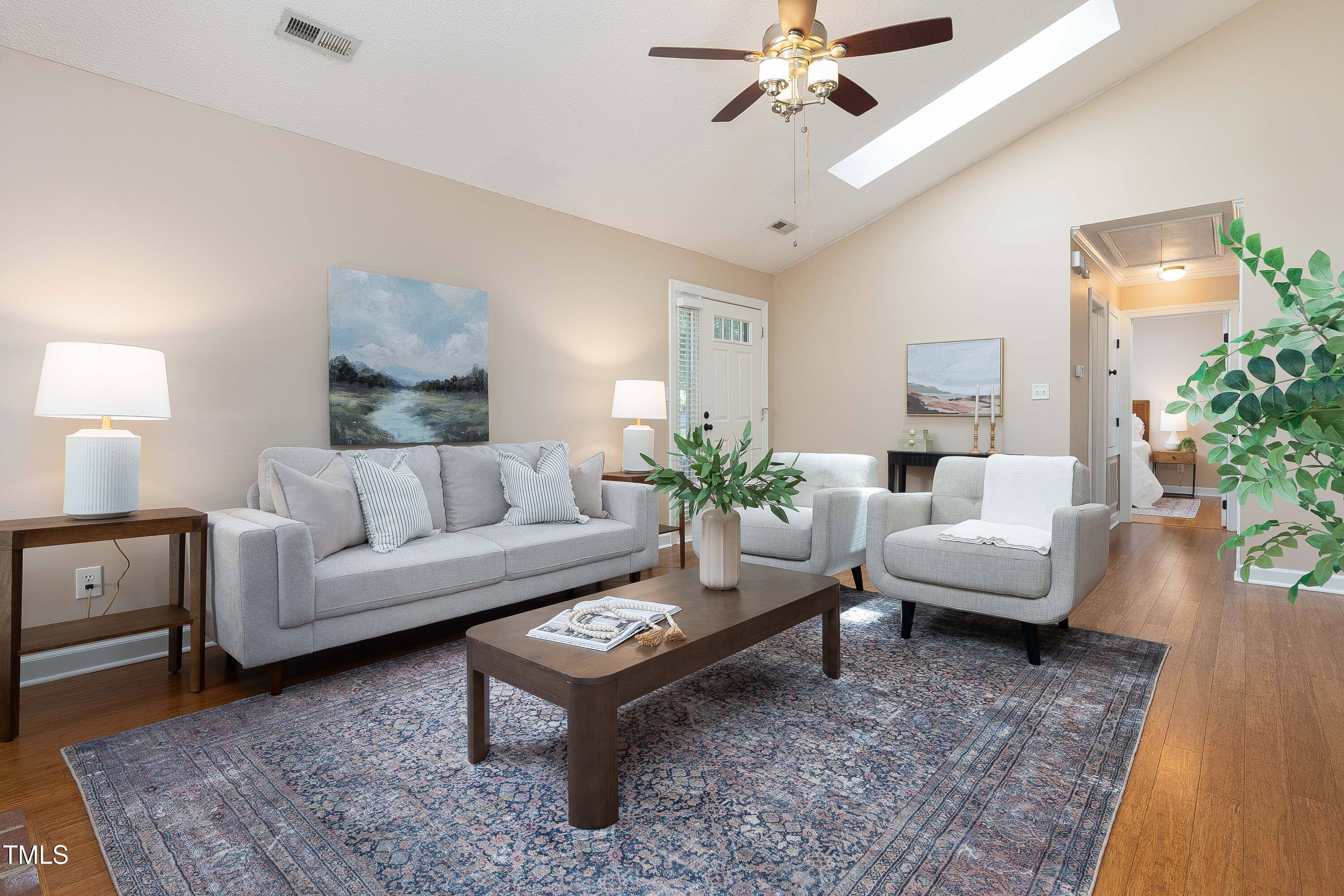 200 West Woodcroft Parkway, Unit 52A Durham, NC 27713 - Photo 5 of 21 a living room with furniture a chandelier and a rug