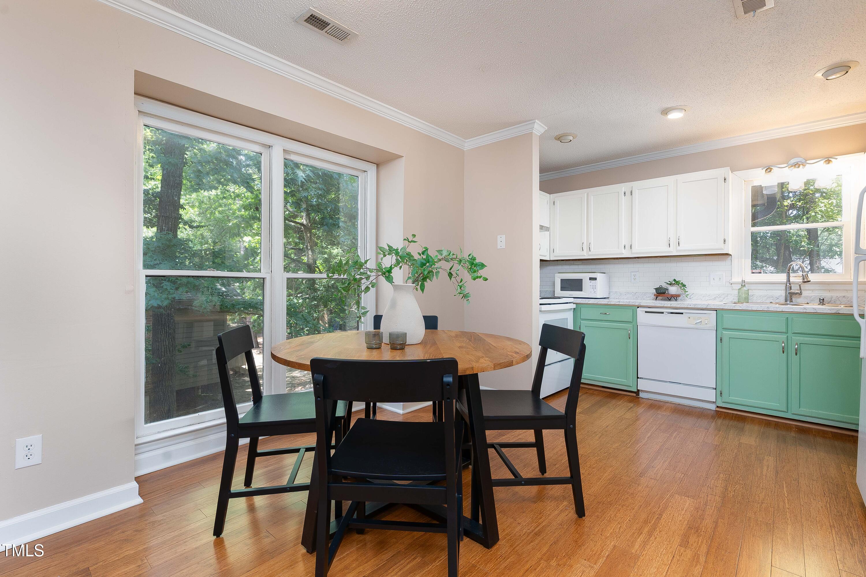 200 West Woodcroft Parkway, Unit 52A Durham, NC 27713 - Photo 7 of 21 a view of a dining room with furniture and wooden floor