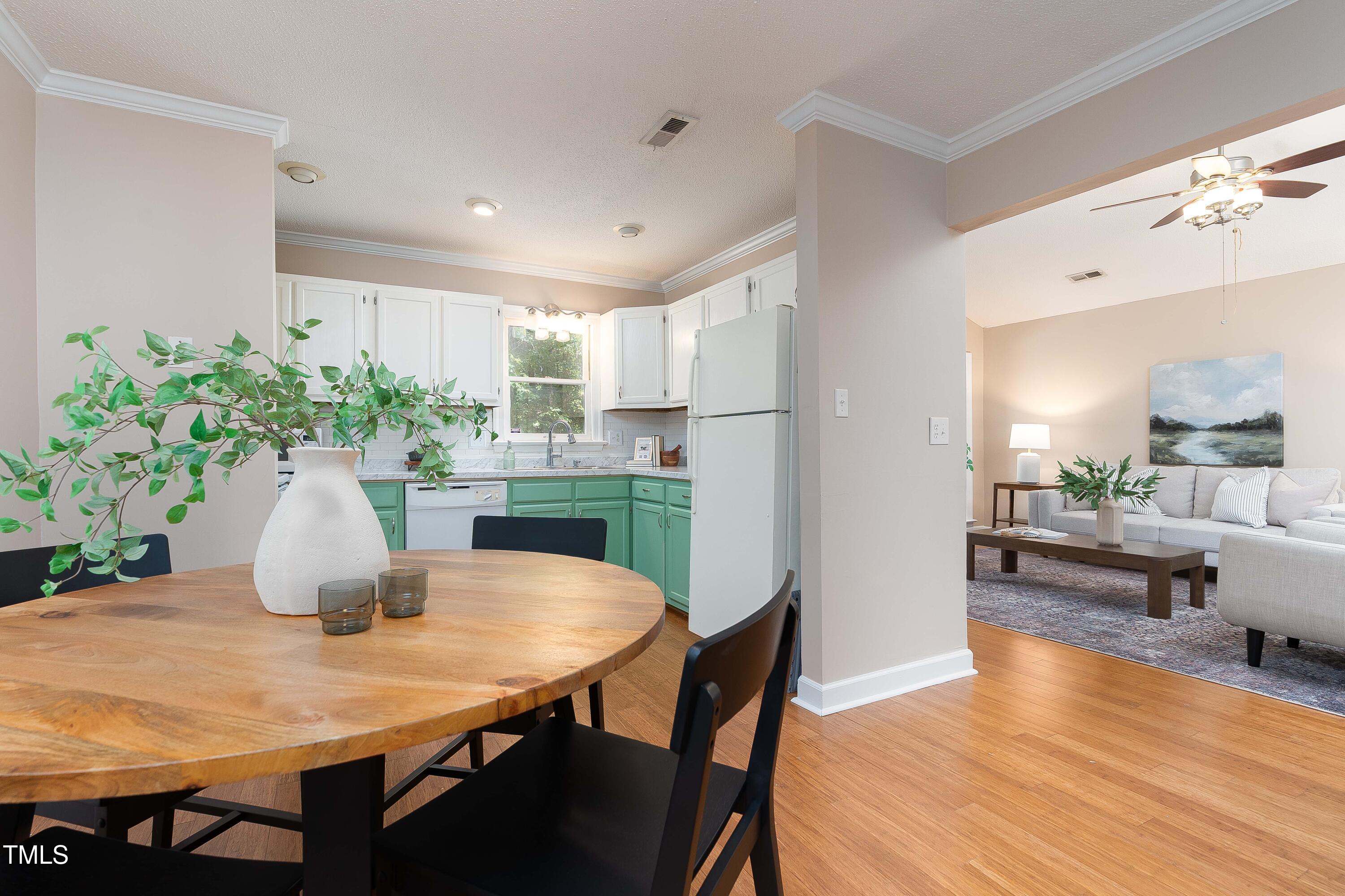 200 West Woodcroft Parkway, Unit 52A Durham, NC 27713 - Photo 8 of 21 a kitchen with a table and chairs in it