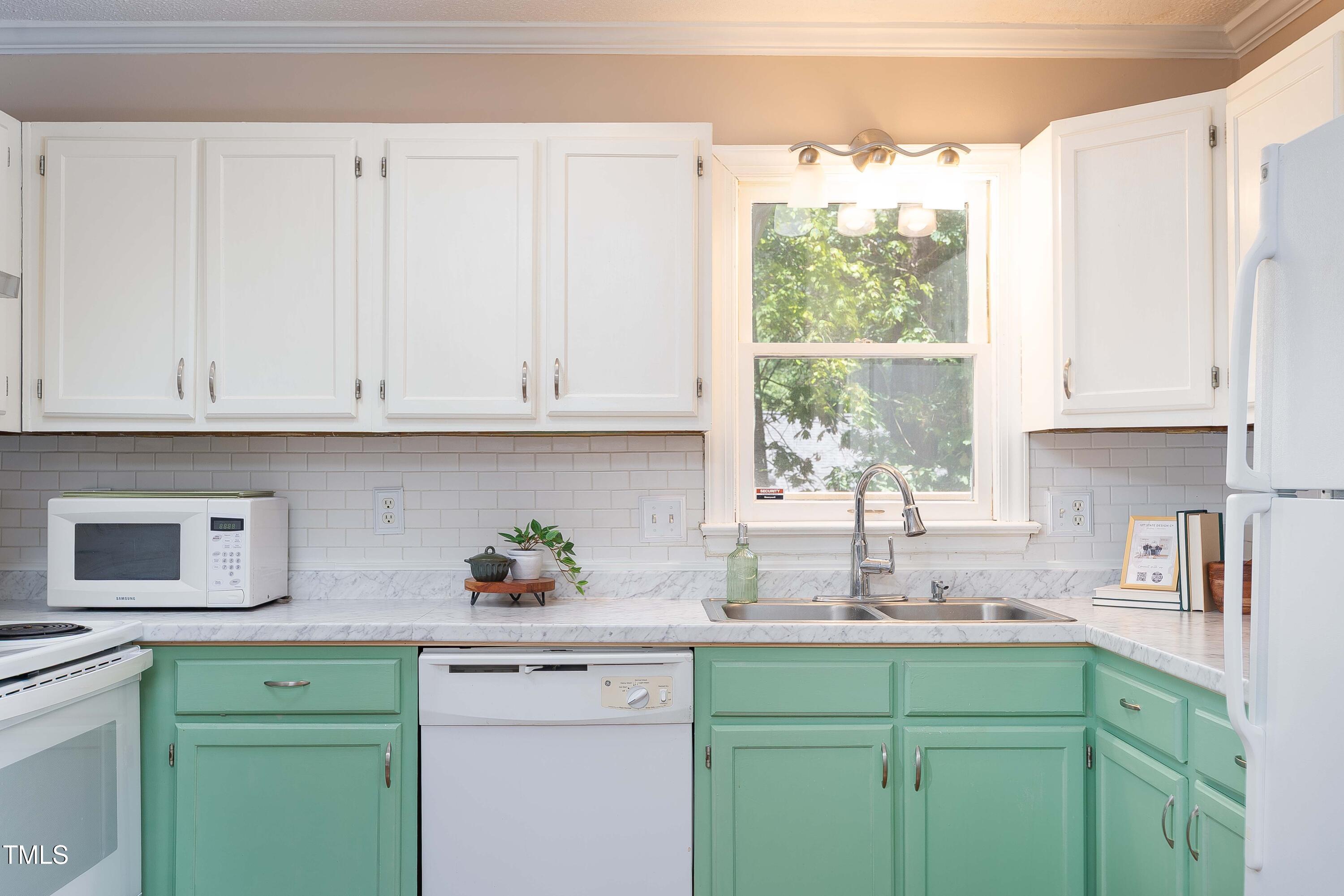 200 West Woodcroft Parkway, Unit 52A Durham, NC 27713 - Photo 9 of 21 a kitchen with stainless steel appliances granite countertop white cabinets sink and window