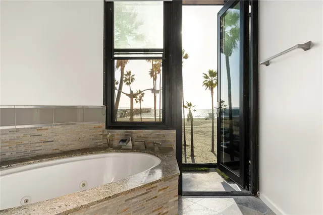 a bathroom with bathtub and window