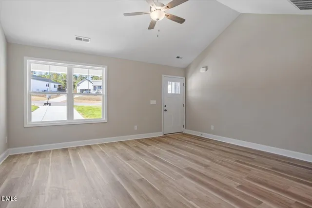 wooden floor in an empty room with a window