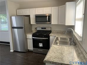 3324 Meadowbridge Road Richmond, VA 23222 - Photo 11 of 36 a kitchen with granite countertop a refrigerator stove and microwave