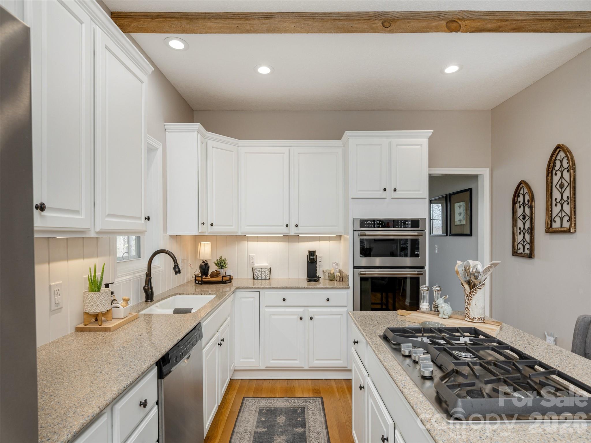 417 Blue Mist Way Arden, NC 28704 - Photo 18 of 48 a kitchen with granite countertop a sink stove and cabinets