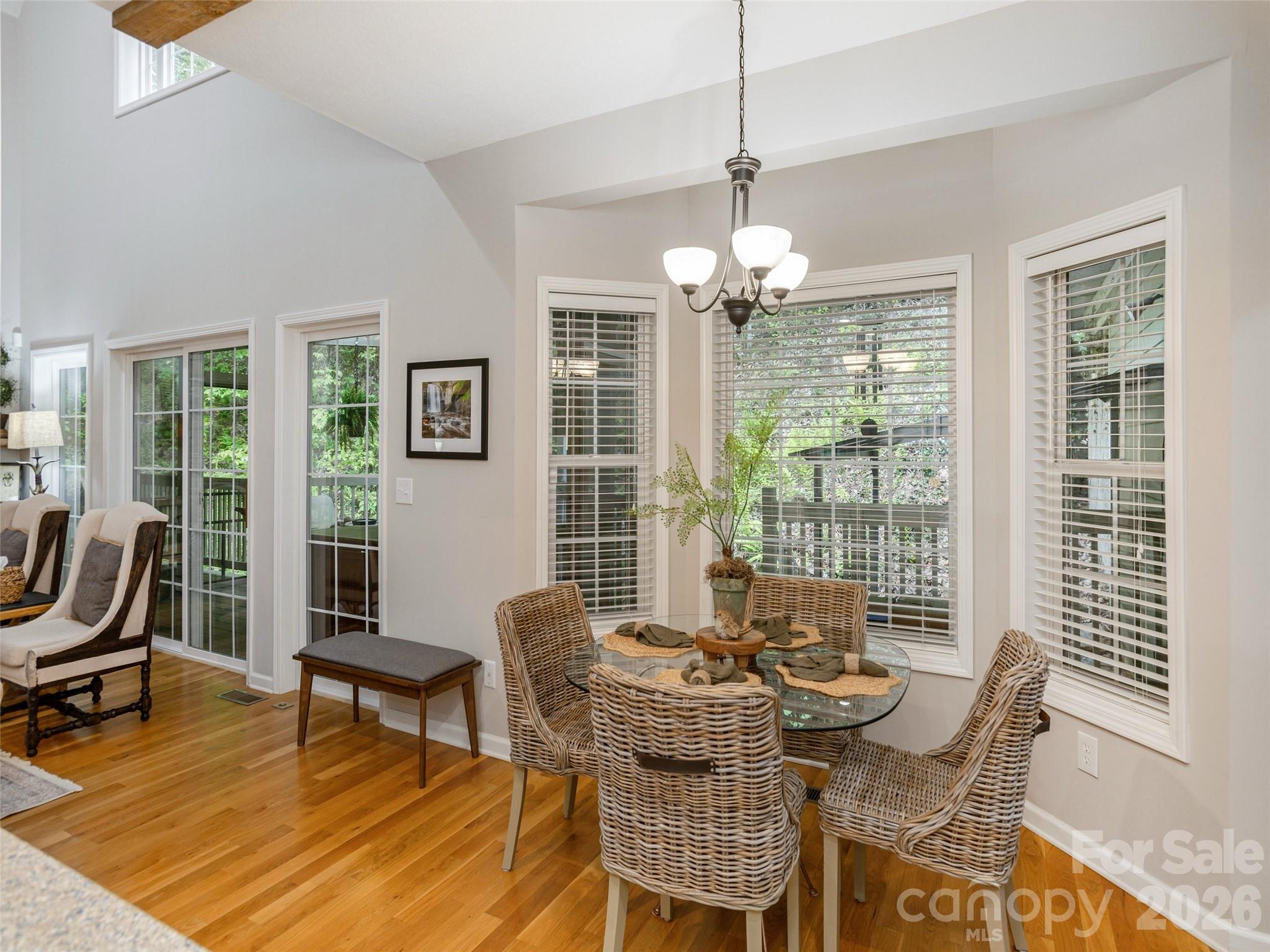 417 Blue Mist Way Arden, NC 28704 - Photo 21 of 48 a dining room with furniture a chandelier and wooden floor