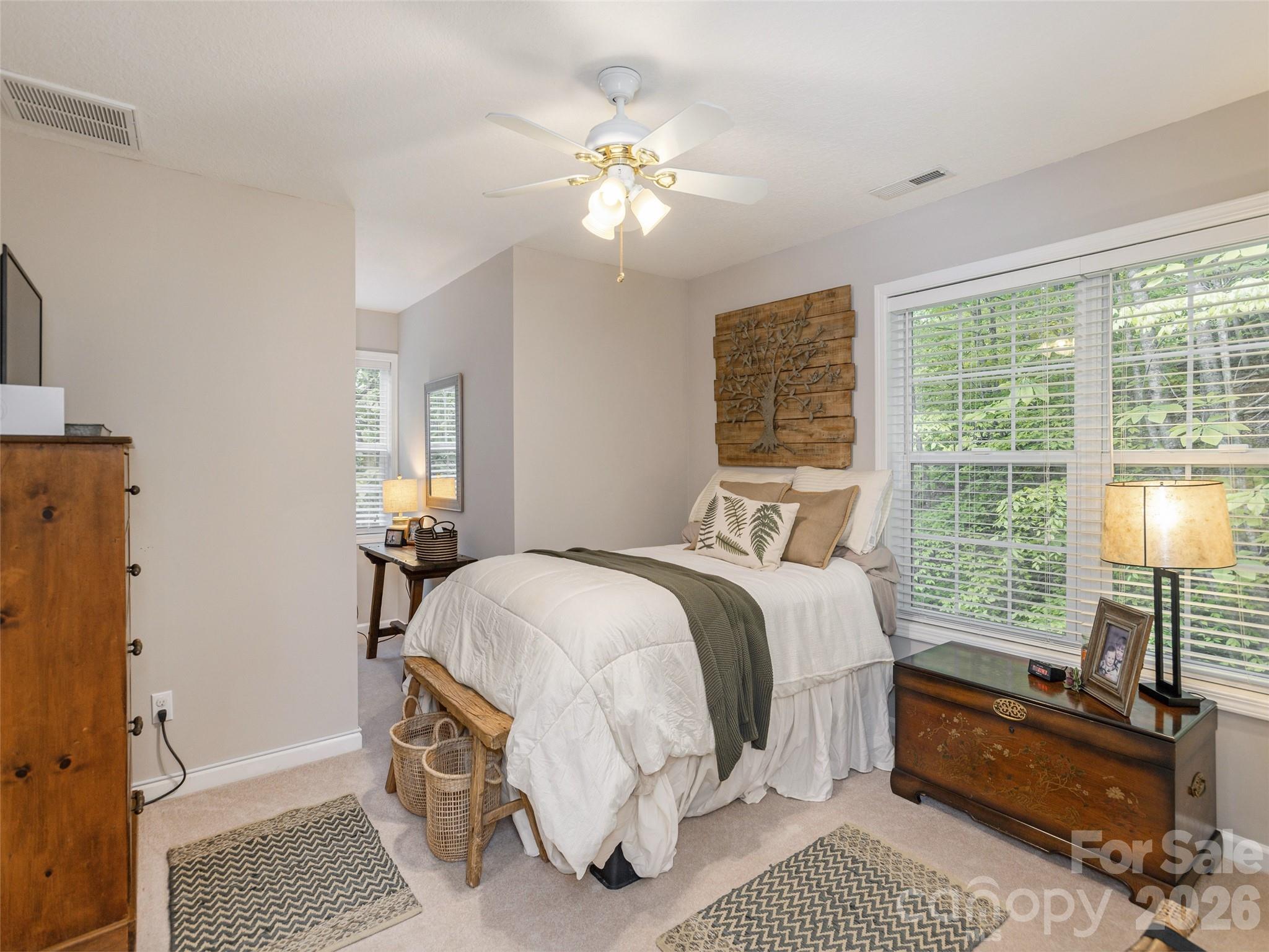 417 Blue Mist Way Arden, NC 28704 - Photo 30 of 48 a bedroom with a bed a chandelier and a window