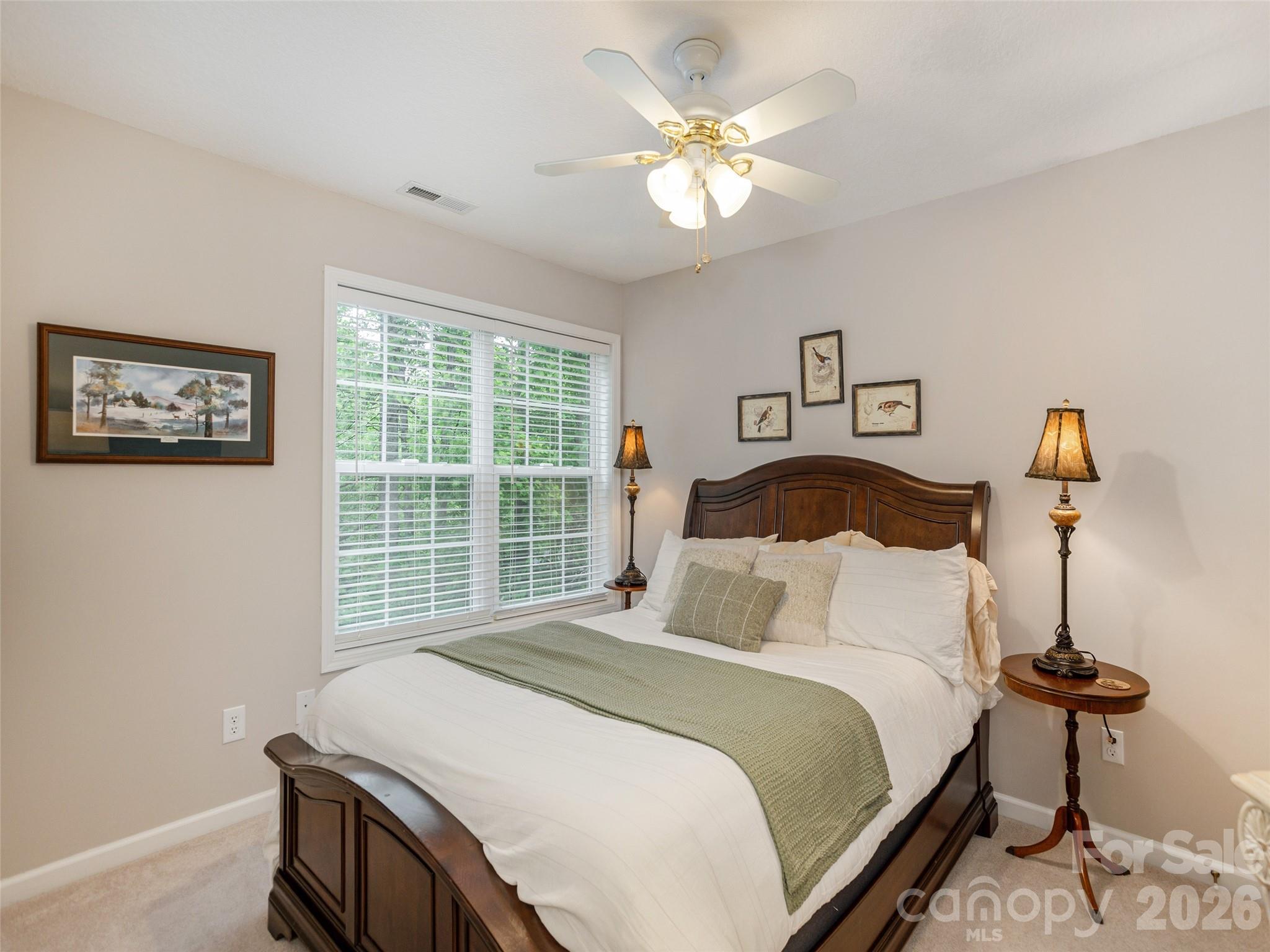 417 Blue Mist Way Arden, NC 28704 - Photo 32 of 48 a bedroom with a bed and a chandelier