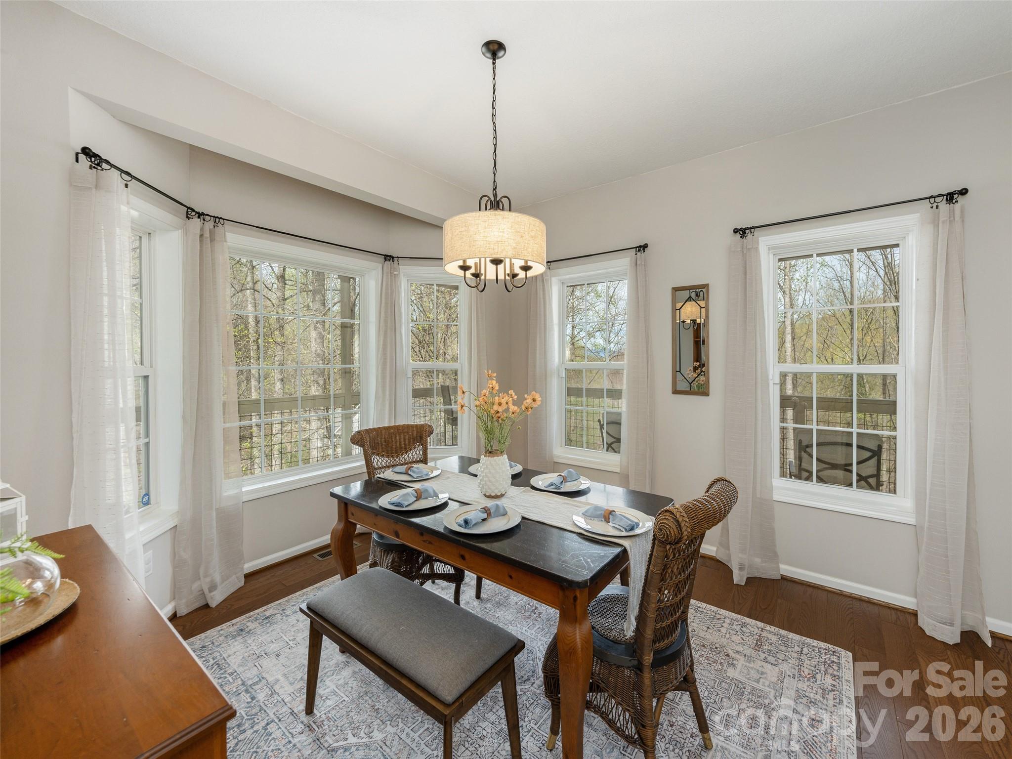 417 Blue Mist Way Arden, NC 28704 - Photo 10 of 48 a dining room with furniture a chandelier and wooden floor