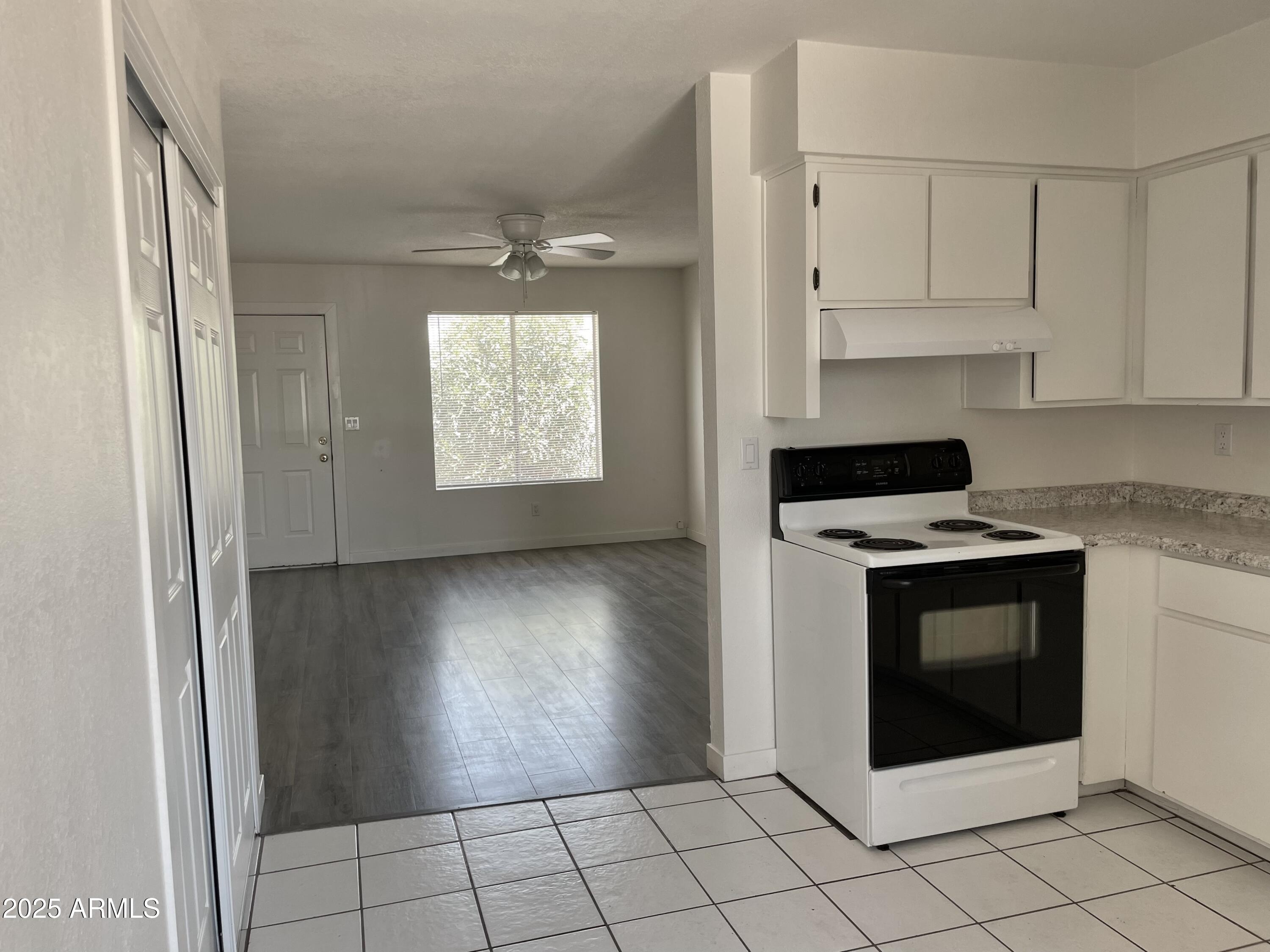 143 South Mountain Road Apache Junction, AZ 85120 - Photo 12 of 38 a kitchen with white cabinets and appliances