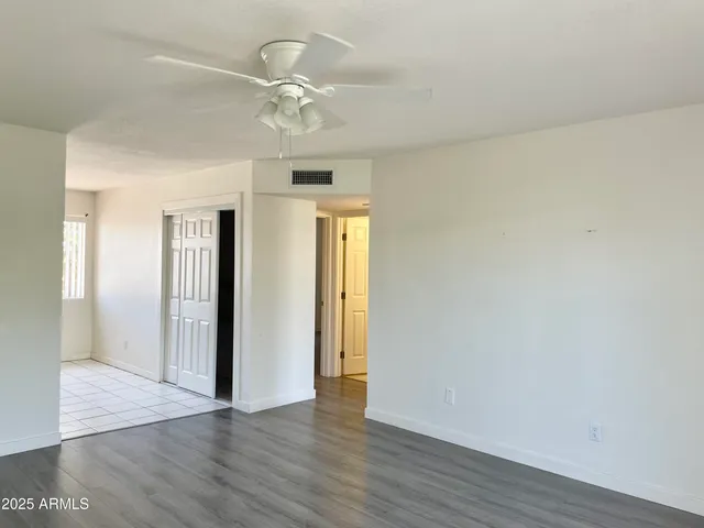 a view of an empty room with wooden floor