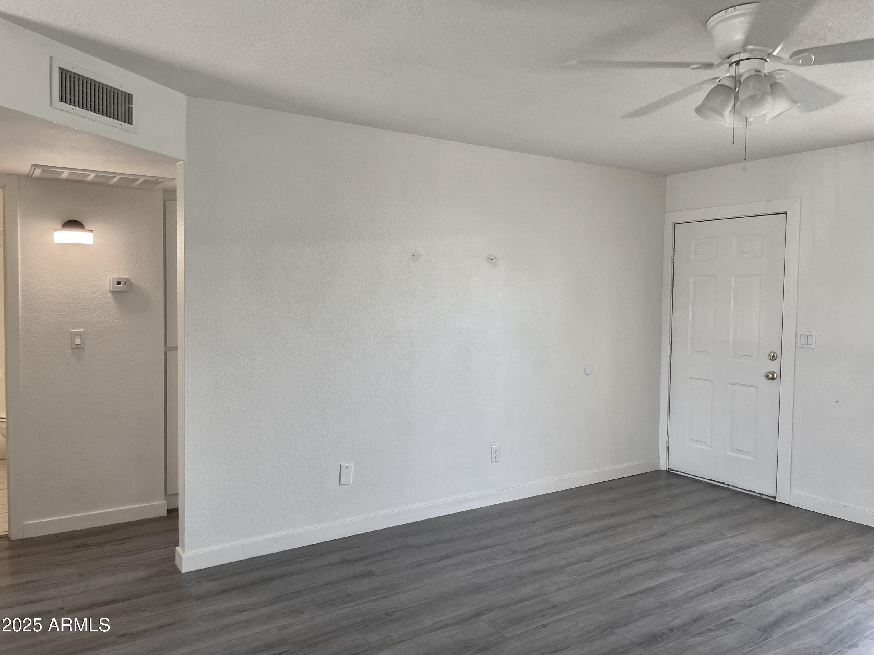 143 South Mountain Road Apache Junction, AZ 85120 - Photo 16 of 38 a view of an empty room with wooden floor